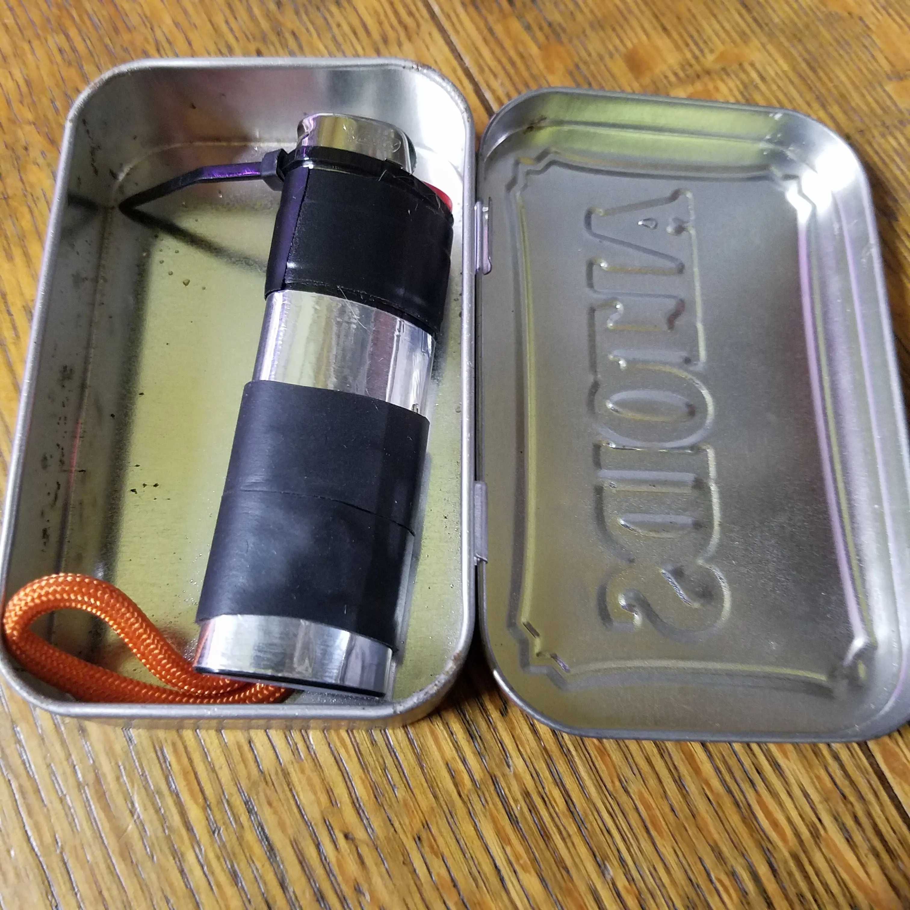 Survival Kit Lighter - Fire Starter outfitted with supplies.